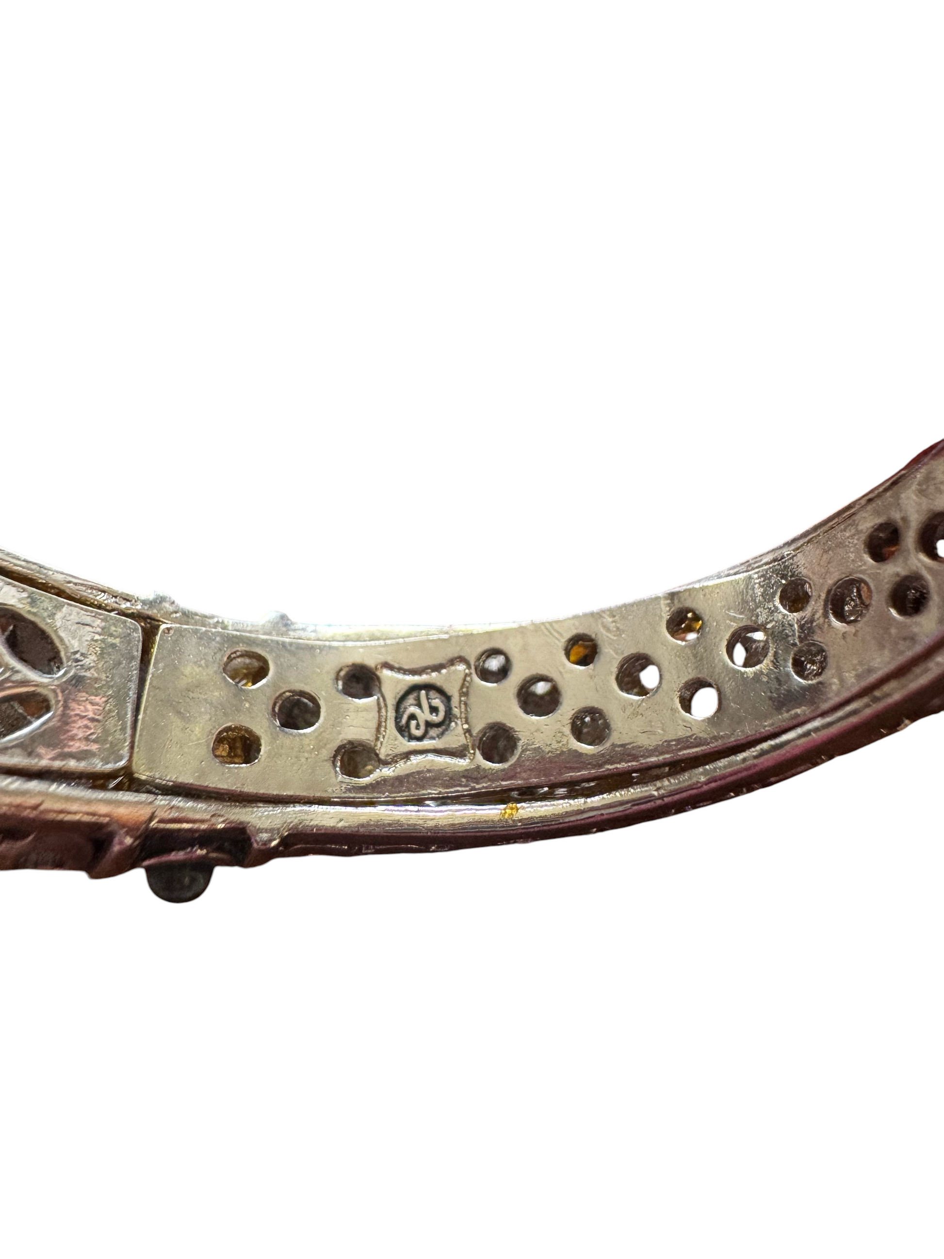Harriet Rose's Home silver-tone metal cuff bracelet interior showing the brand hallmark and intricate lattice detail.