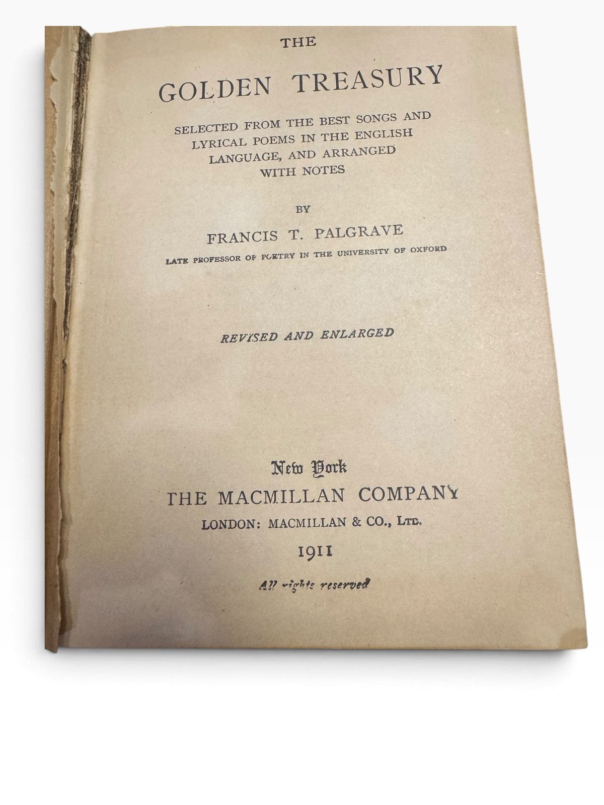 1911 Macmillan edition title page of The Golden Treasury by Francis T. Palgrave with aged paper and visible hinge wear.
