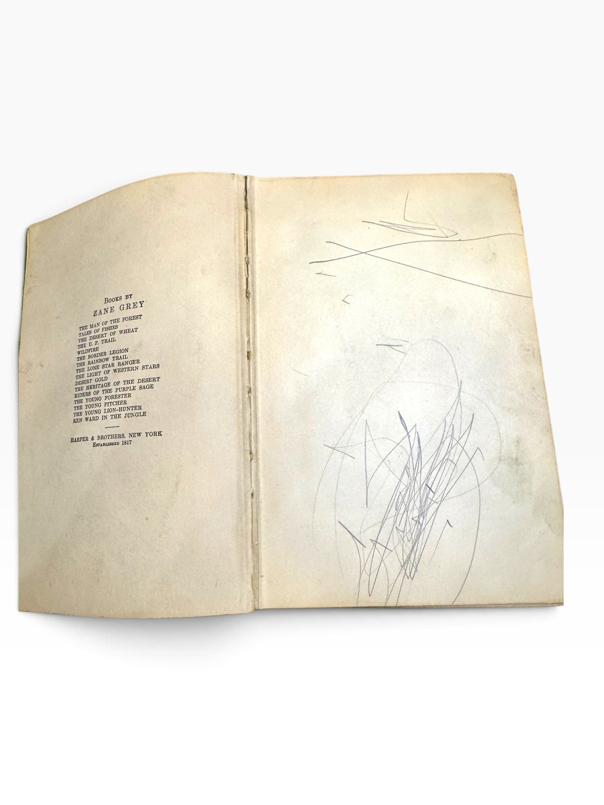 Zane Grey book list page with vintage pencil scribbles on the endpaper of a 1920 Harper and Brothers edition.